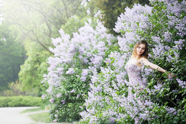 Woman enjoying blooming lilac