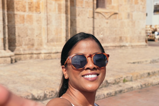 Woman enjoying the colorful streets of the colonial walled city of Cartagena de Indias