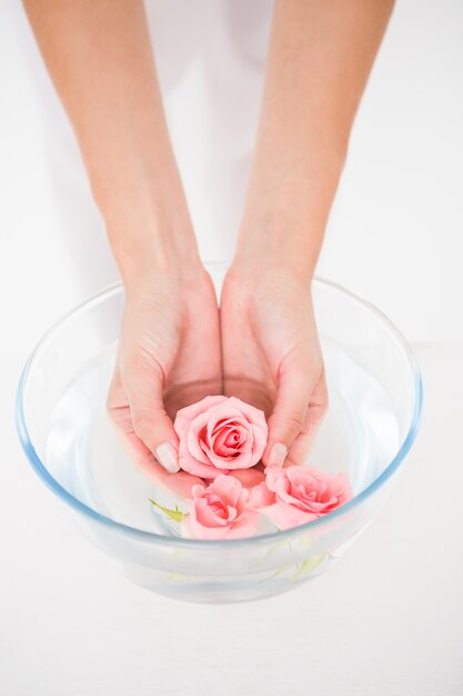 Woman enjoying a hand treatment in a bowl