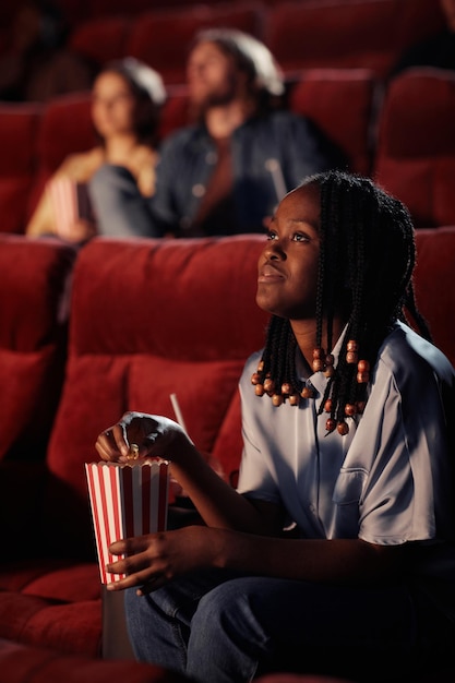 Woman enjoying movie in the cinema