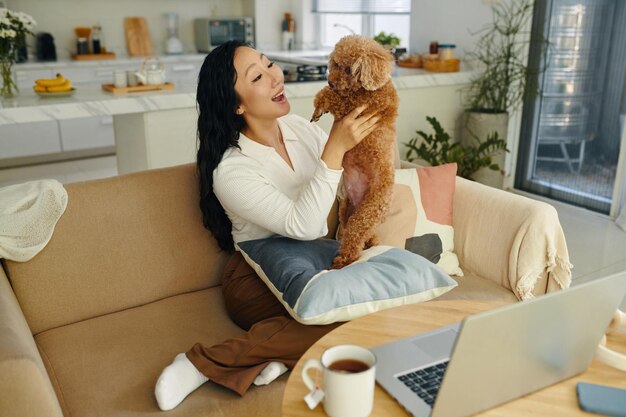 Woman enjoying playing with dog