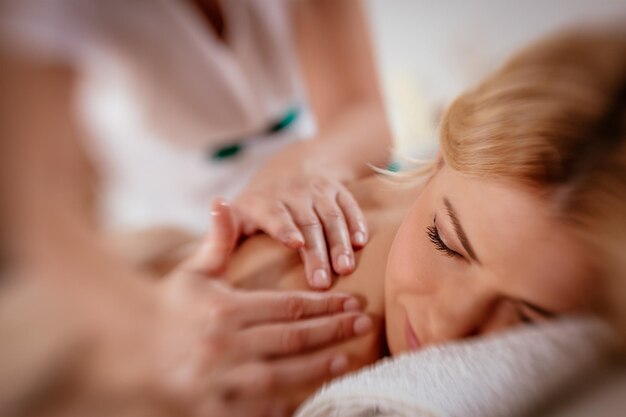 Woman enjoying during a relax massage at the spa.