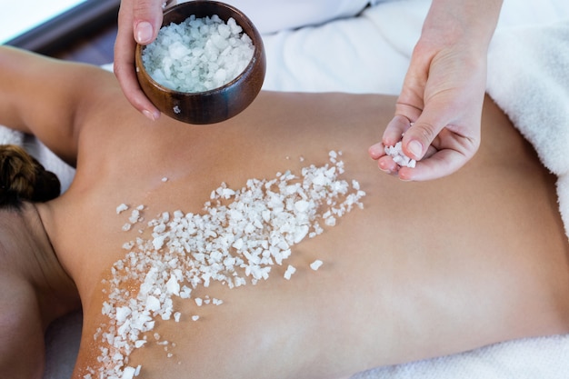 Woman enjoying a salt scrub massage