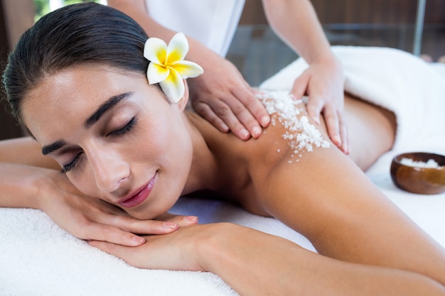 Woman enjoying a salt scrub massage