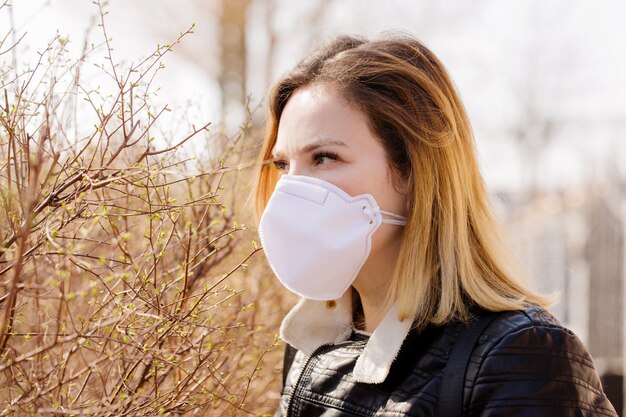 Woman enjoying spring in a mask