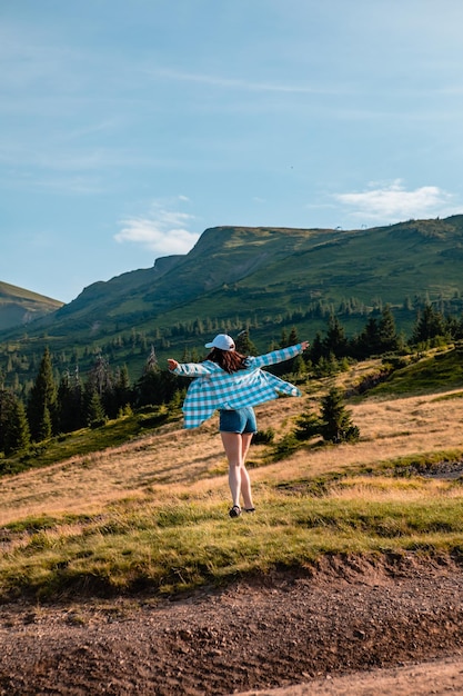 Woman enjoying sunset above the mountains