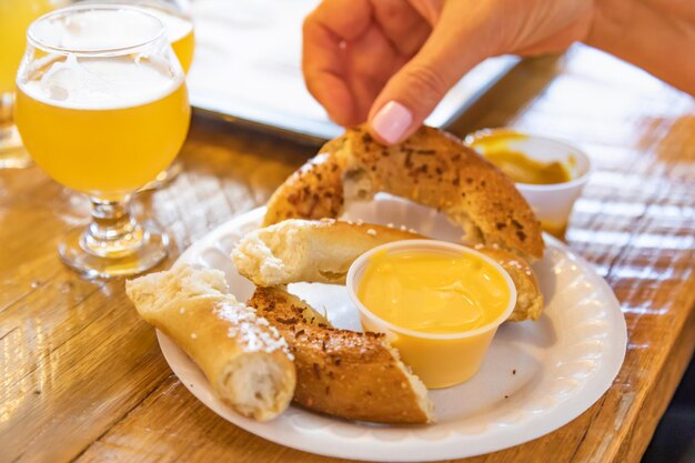 Woman enjoys warm pretzels and micro brew beer