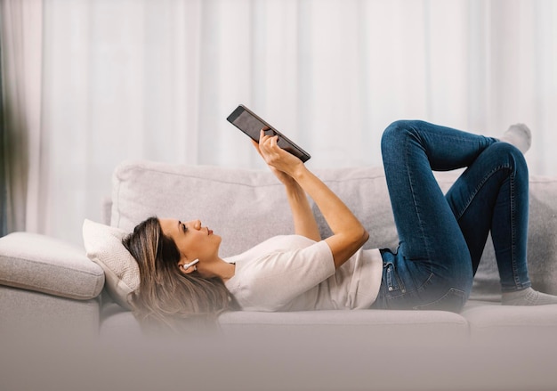 A woman entertains with a tablet in the living room