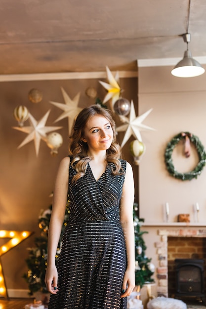 Woman in evening dress and Christmas tree