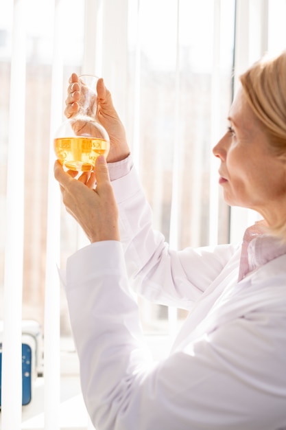 Woman examining chemical reaction