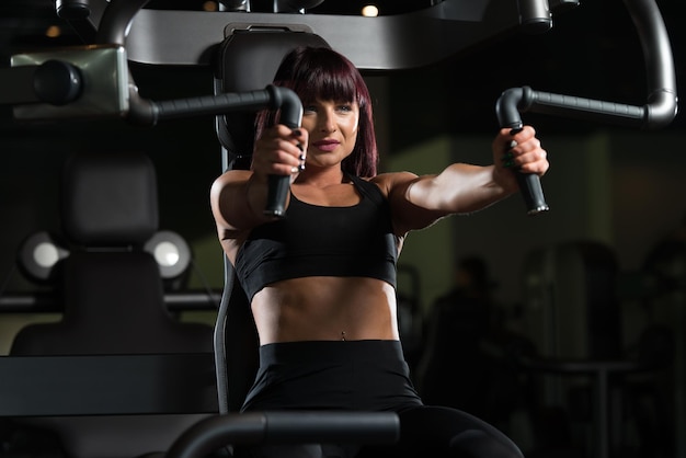 Woman Exercising Chest In The Gym