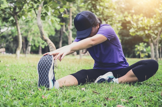 woman exercising on grassy field