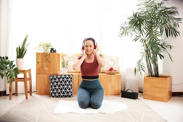 Woman exercising at home. Fitness with music