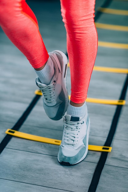 Woman exercising on ladders in the gym