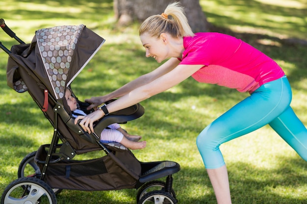 Woman exercising with baby stroller