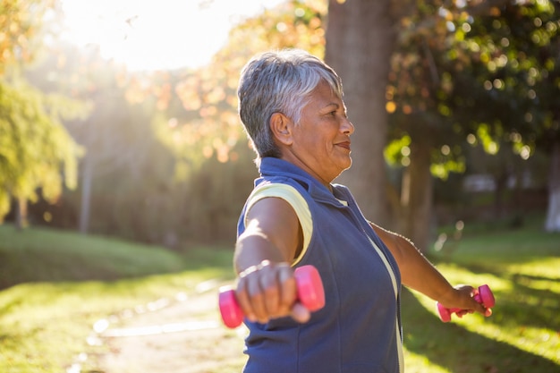 Woman exercising with dumbbell at park