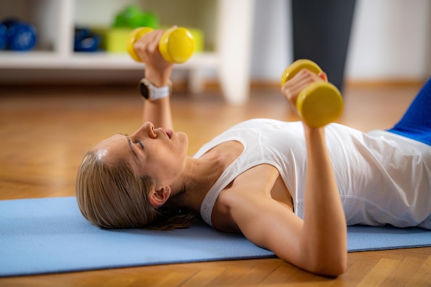 Woman Exercising with Dumbbells Shoulder Press Exercise