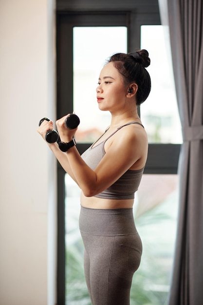 Woman Exercising with Dumbbells