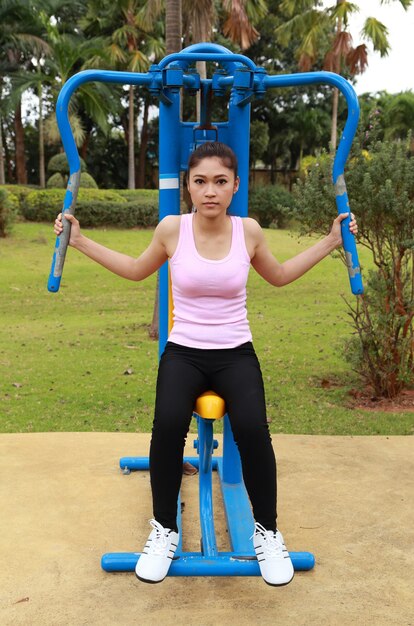 woman exercising with exercise equipment in the public park