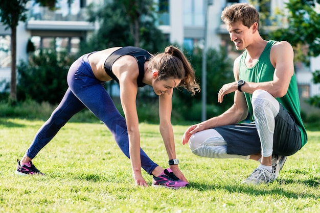 Woman exercising with young man