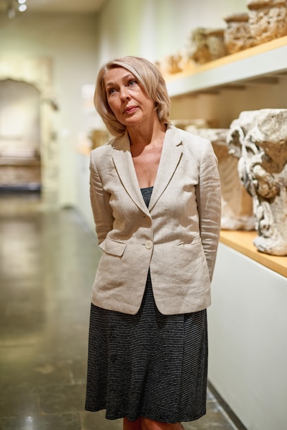 Woman exploring medieval expositions in museum