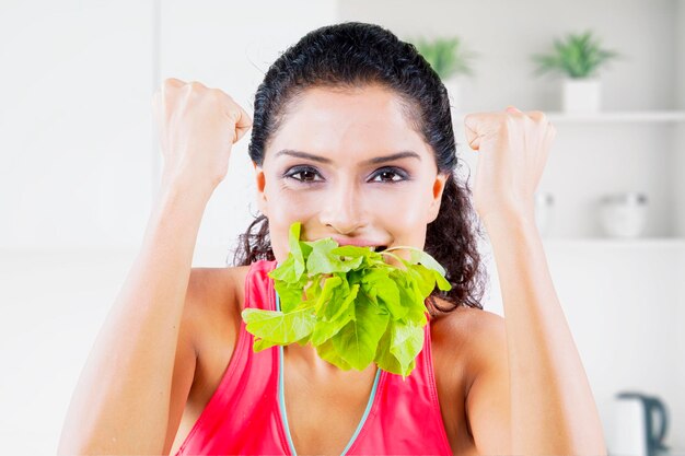 Woman expresses happy while bite leaves at home