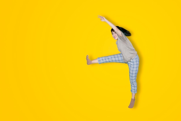 Woman expressing happy while jumping on studio