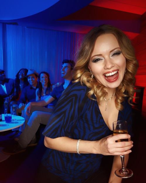 Woman face or laughing with champagne glass in party New Year celebration or holiday event in nightclub Portrait smile or happy person with alcohol drink diversity people and friends in Portugal