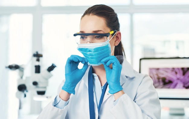 woman face and mask in laboratory for safety experiment and protection from chemical test career female scientist or gloves in healthcare for medical sterility infection transmission and rules