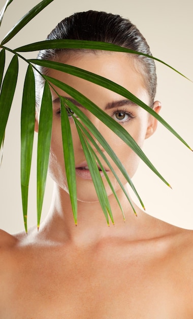 woman face and natural beauty with leaf for skincare cosmetics or healthy facial treatment portrait of beautiful female with organic plant leafs or satisfaction for self love self care or skin