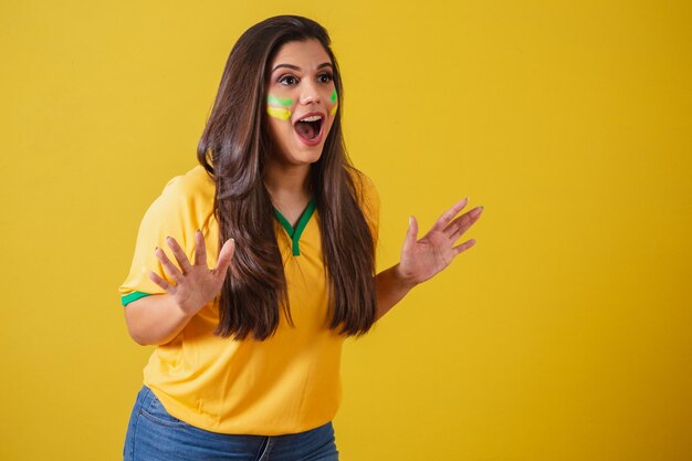 Woman fan of brazil world cup 2022 football championship amazed\
wow incredible unbelievable surprised to watch a football\
match