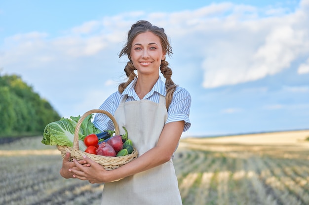 Woman farmer apron standing farmland smiling