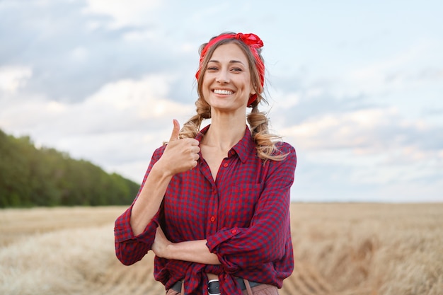 Woman farmer standing farmland smiling Female agronomist specialist farming agribusiness Happy positive caucasian worker agricultural field