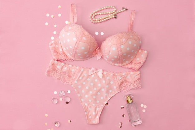  Woman fashion accessories, pink polka dot lingerie on pink background