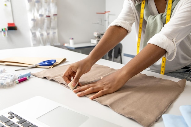 woman in fashion workshop using chalk to design a stylish dress with modern textiles creative ideas
