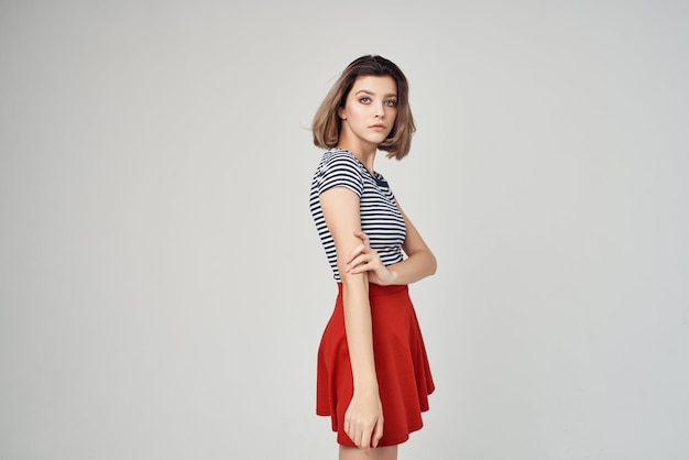 Woman in fashionable clothes Red skirt posing Studio High quality photo