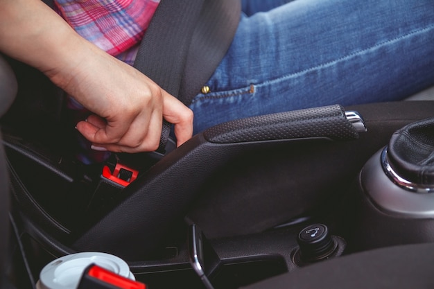 Woman fastens a seat belt