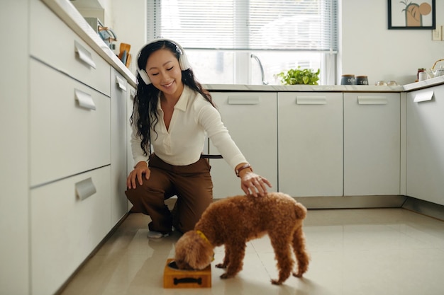 Woman feeding dog