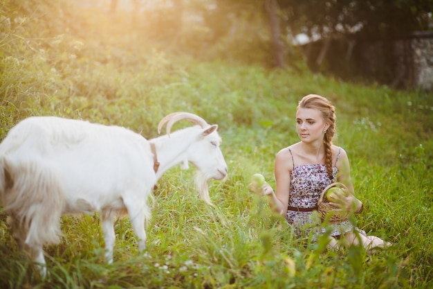 Woman feeding goat