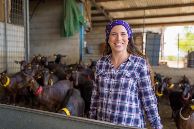 woman feeding the goats on an old farm