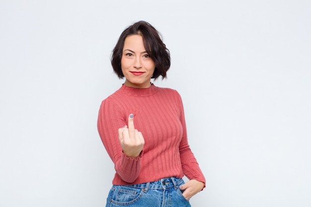 Woman feeling angry, annoyed, rebellious and aggressive, flipping the middle finger, fighting back