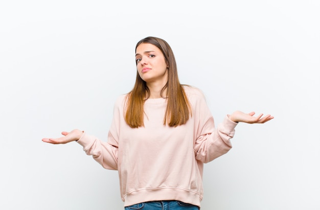 woman feeling clueless and confused, having no idea, absolutely puzzled with a dumb or foolish look