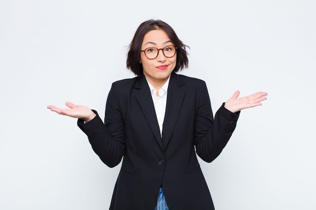 Woman feeling puzzled and confused, doubting, weighting or choosing different options with funny expression