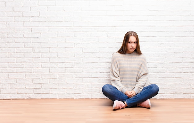 woman feeling sad, upset or angry and looking to the side with a negative attitude, frowning in disagreement