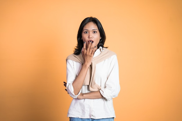 Woman feeling shocked and suprised over isolated background