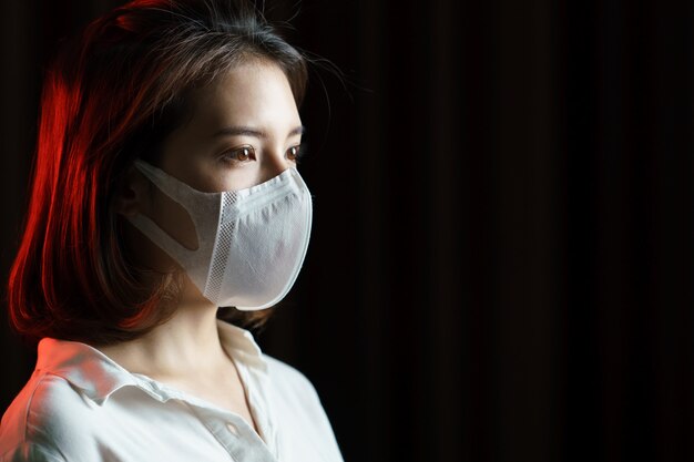 Woman feeling sick and wearing protective mask