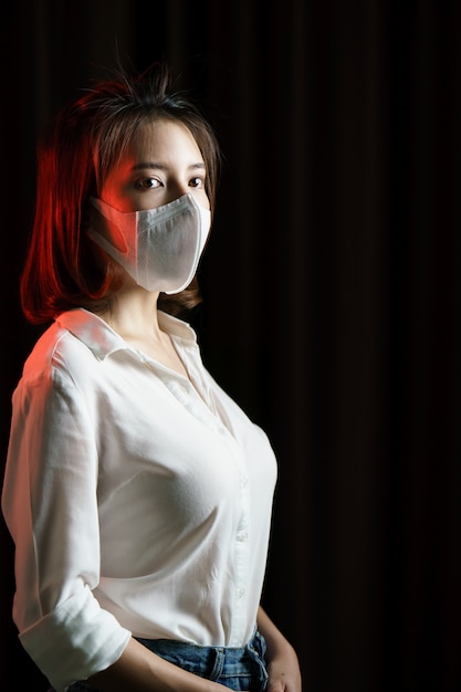 Woman feeling sick and wearing protective mask