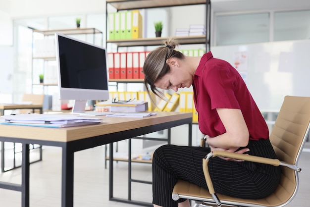 Woman feels acute pain in stomach putting palms on belly female employee suffers from ache pain