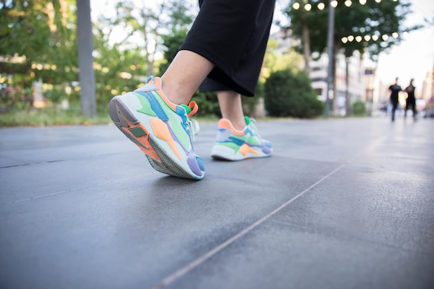 Woman feet sport shoes walking in streetxAxAxAxA