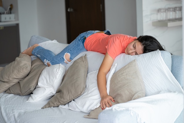 Woman fell asleep in an unusual position on the back of the sofa